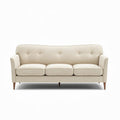 Fabric three-seater sofa with button tufting and wooden legs in light beige